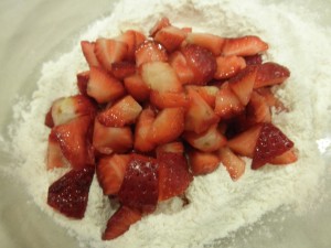 Add strawberry chunks to flour